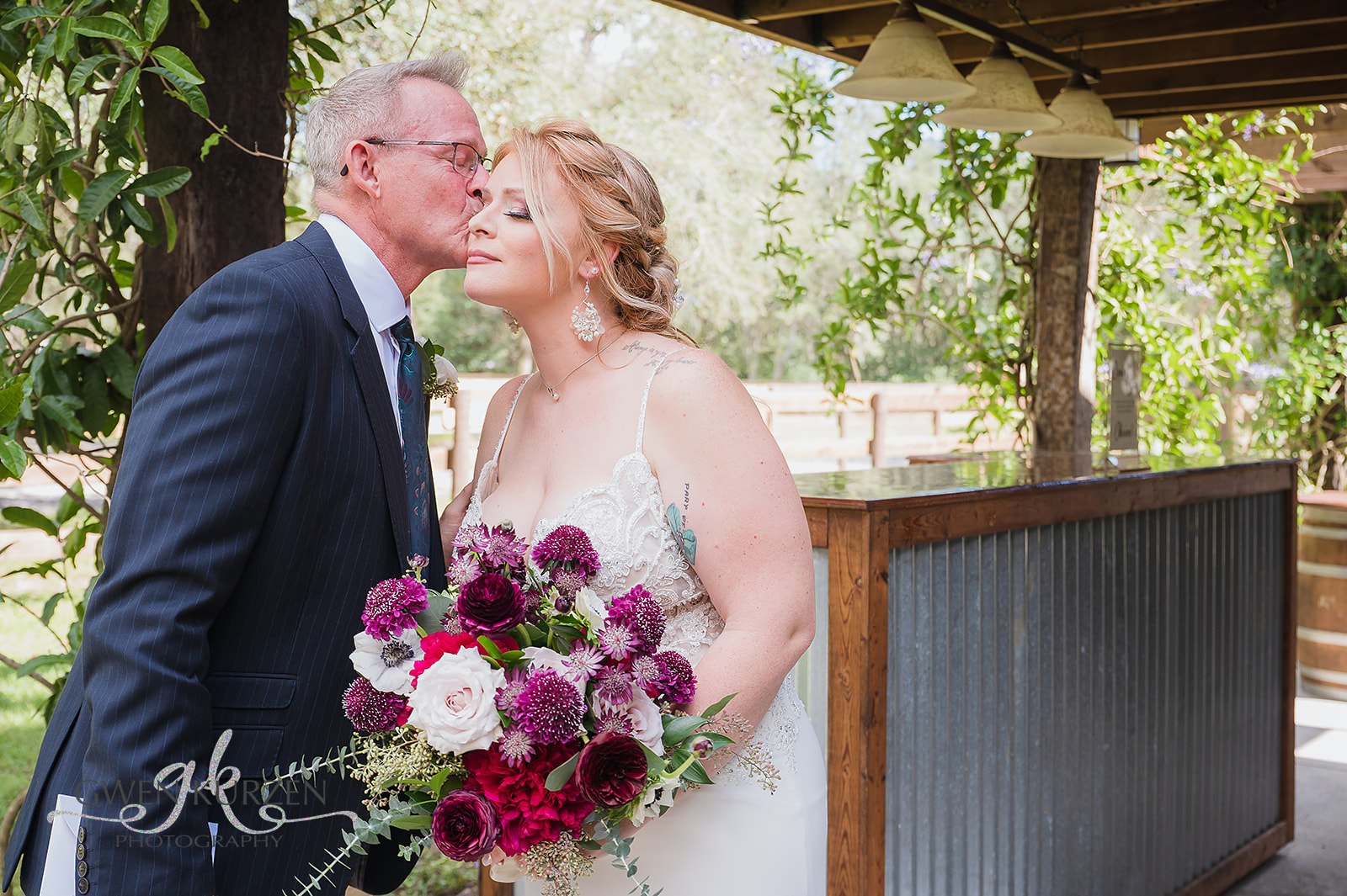 The-Bride-Getting-A-Kiss-On-Cheek-By-Special-Guest